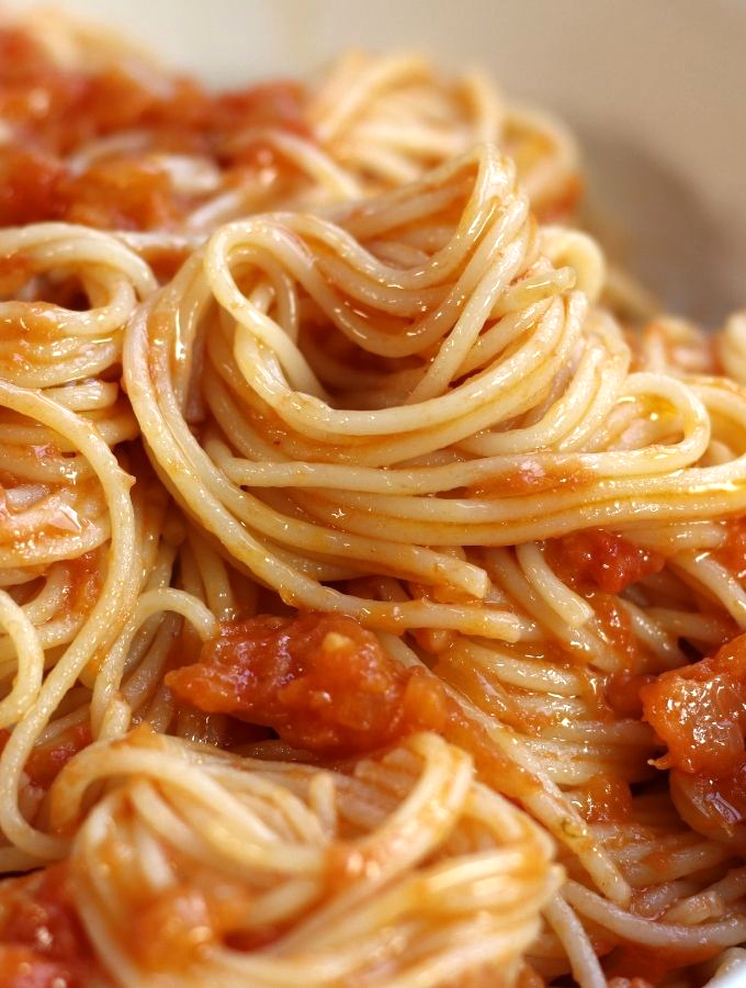 Up close photo of Simple Pomodoro Sauce served over angel hair pasta.