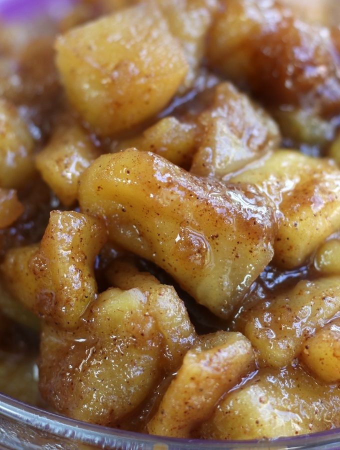 Up close photo of Apple Compote in a clear glass bowl.