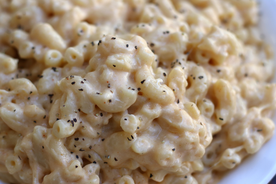 Macaroni and Cheese garnished with black pepper.