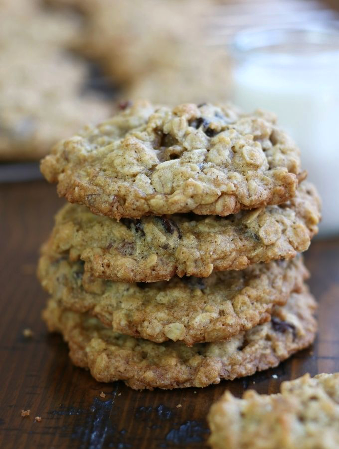 A stack of Oatmeal Raisin Coconut Cookies on a wooden table.