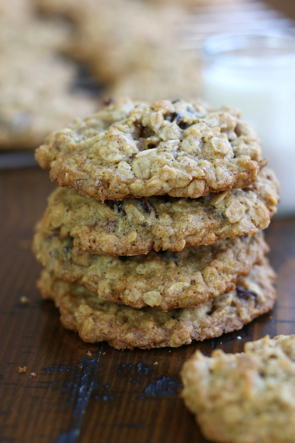 Oatmeal Raisin Cookies sitting next to a glass of milk.