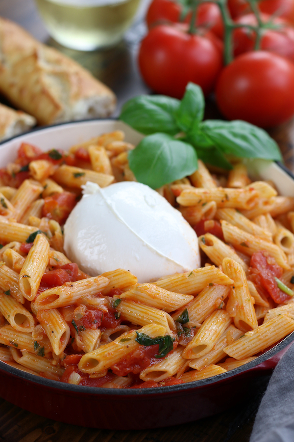 Tomato Penne Pasta garnished with fresh basil.