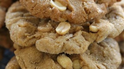 A stack of the Best Peanut Butter Cookies loaded with peanut halves and peanut butter chips.