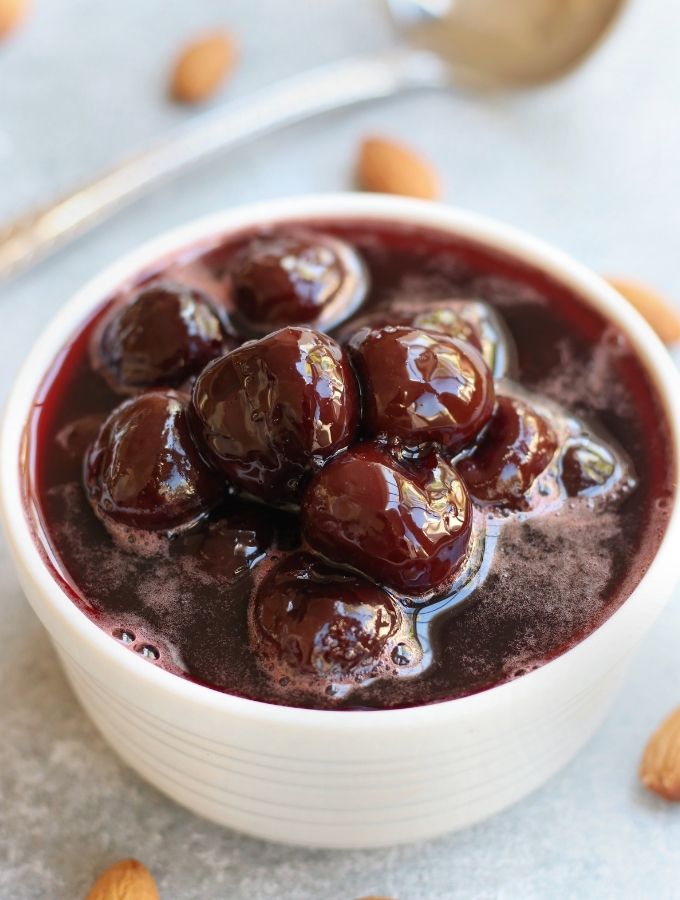 Cherry Amaretto Compote in a small white bowl.