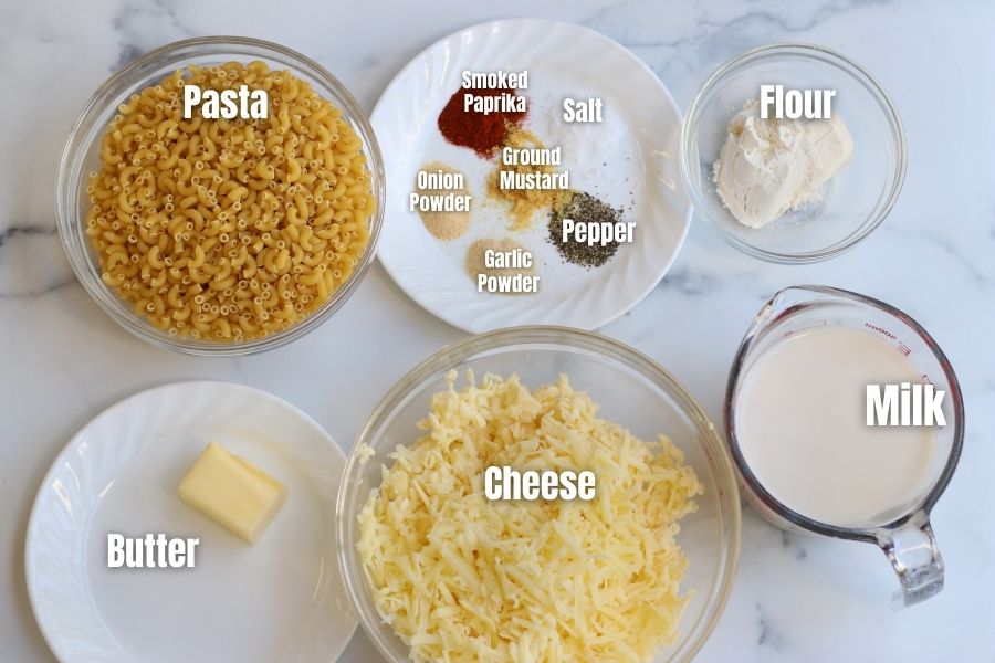 Ingredients for Creamy Mac and Cheese on a white countertop.
