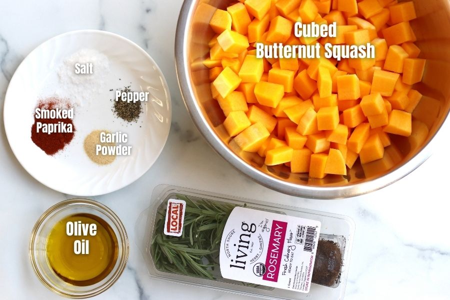 Ingredients for Roasted Butternut Squash laid on a white countertop.