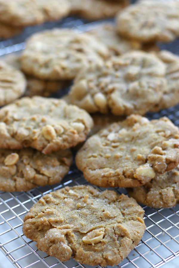 Natural Peanut Butter Cookies scattered on a cooling rack.
