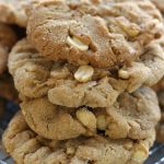 4 Peanut Butter Cookies Stacked together on a wire cooling rack.