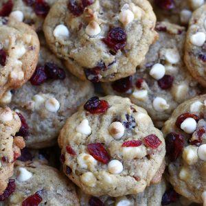 A platter full of White Chocolate Chip Cookies with Cranberries.