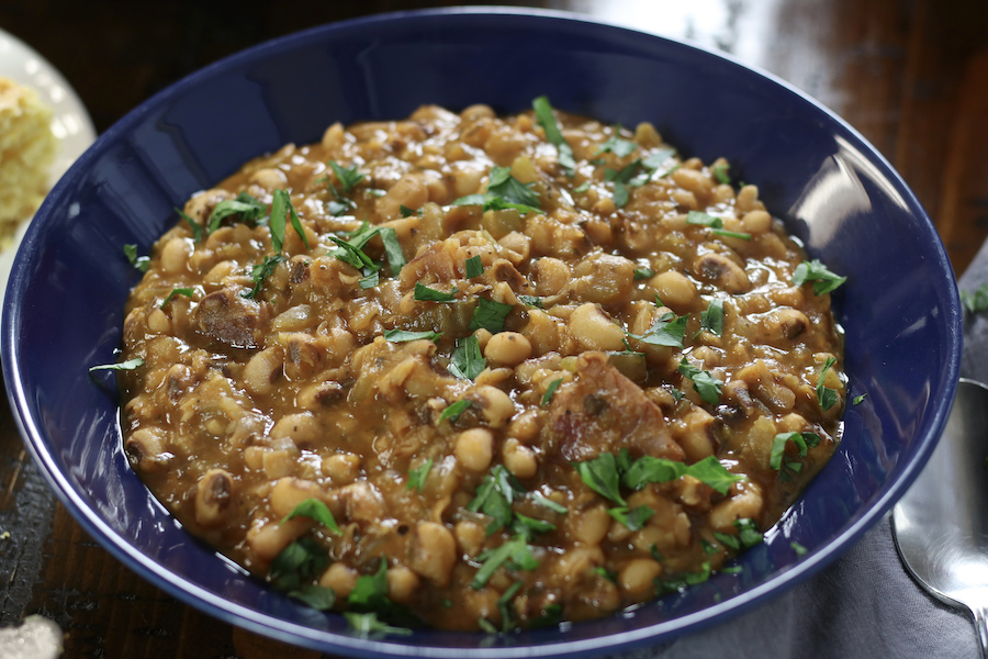 A serving of the Best Black Eyed Peas Recipe sitting on a brown table.