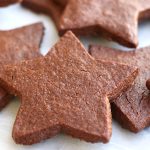 Chocolate Cut Out Cookies scattered on a white marble platter.