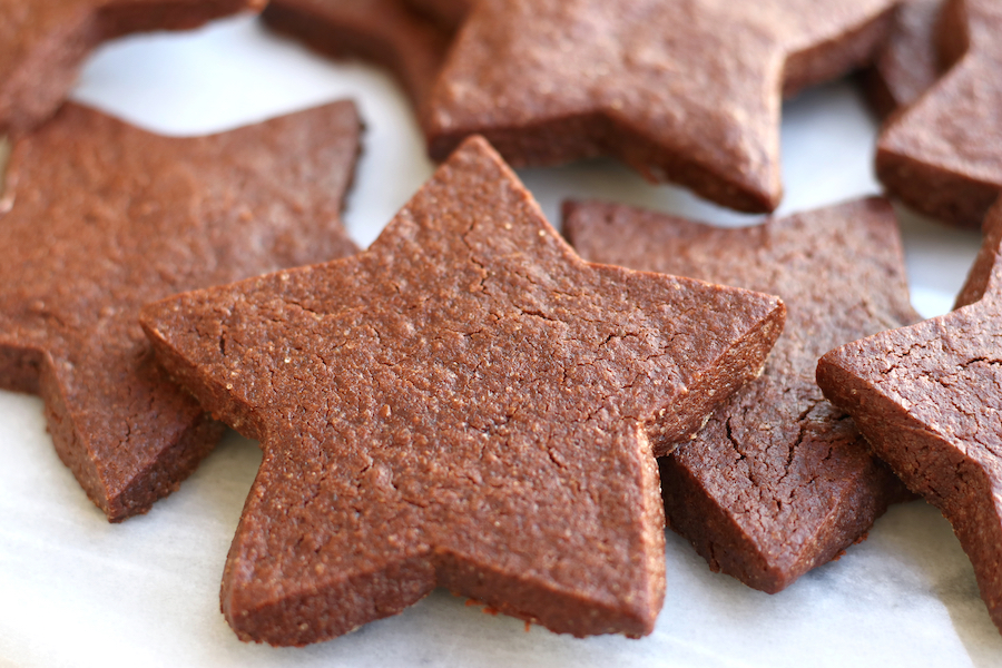 Chocolate Cut Out Cookies scattered on a white marble platter.