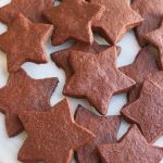 Star shaped Chocolate Sugar Cookies on a white platter.
