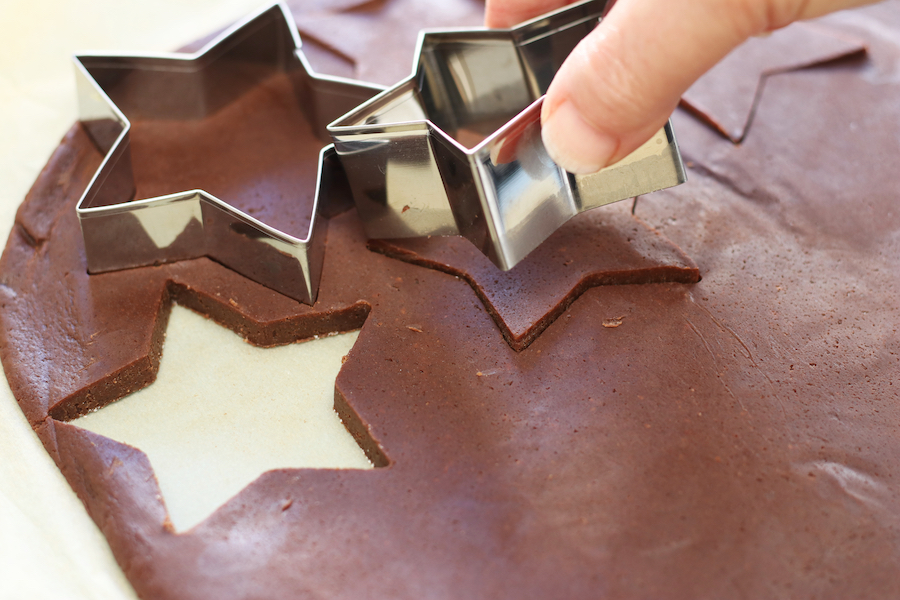 Star cookie cutter cutting Chocolate Sugar Cookie Dough.