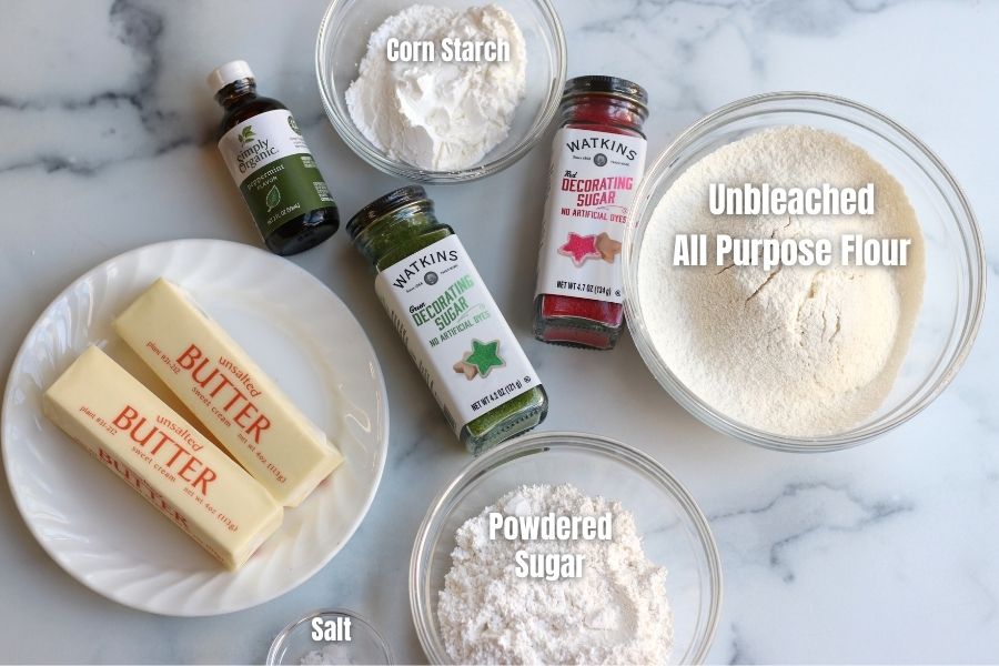 Ingredients for Whipped Shortbread Cookies on a white marble countertop.