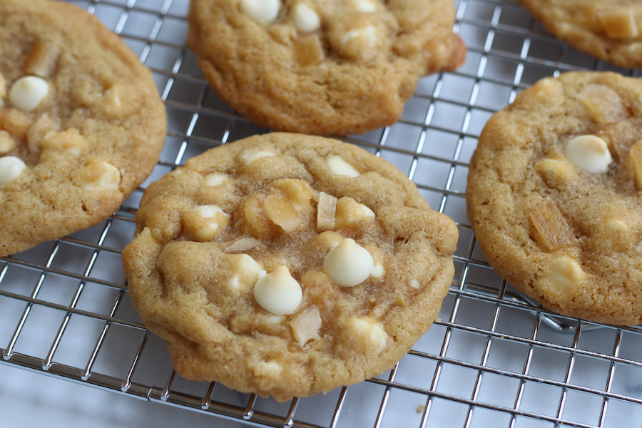 Lemon Cookies with White Chocolate and candied lemon pieces on a wire cooling rack.