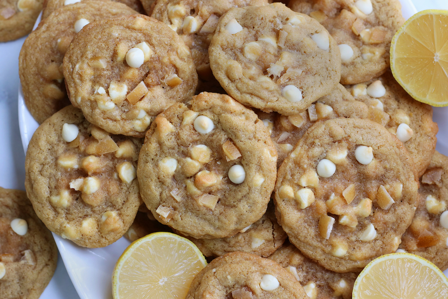 Lemon White Chocolate Chip Cookies piled on a white platter.