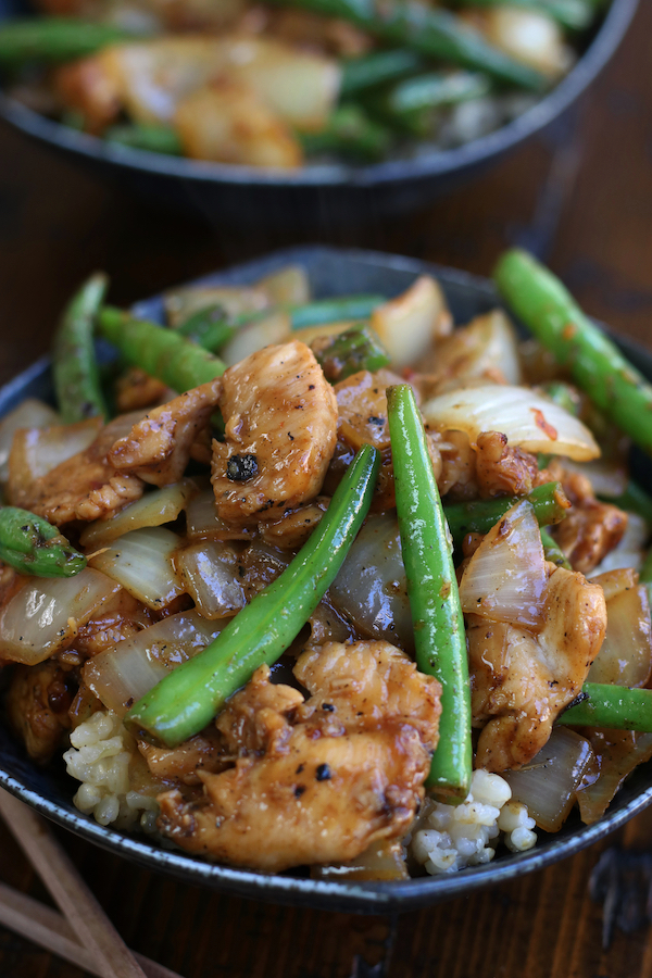 Chicken and Green Beans stir fried together and served into a bowl.