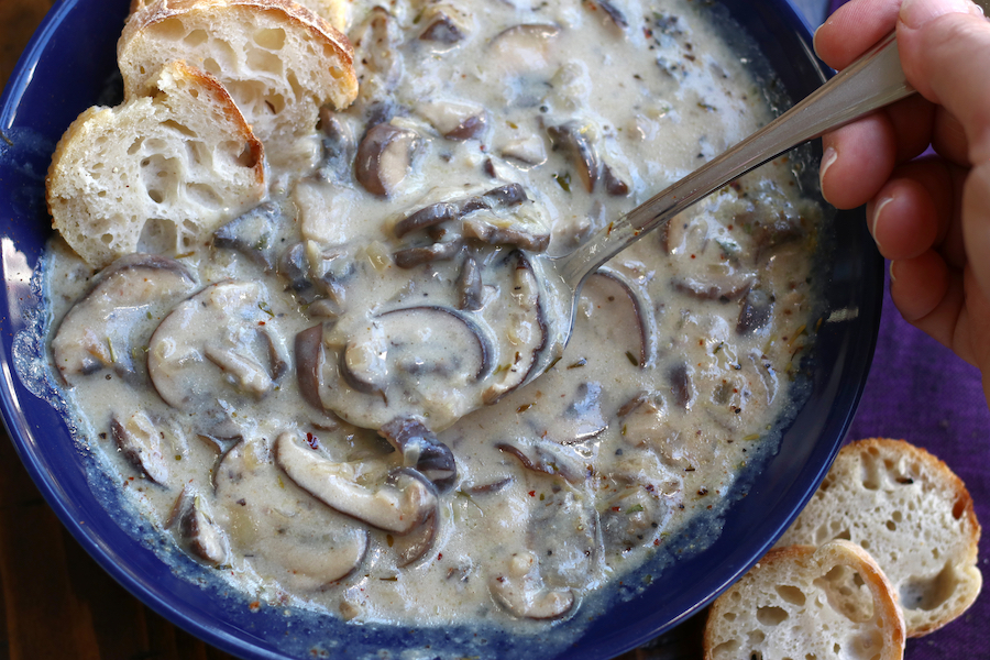 Cream of Mushroom Soup being eaten from a blue bowl.