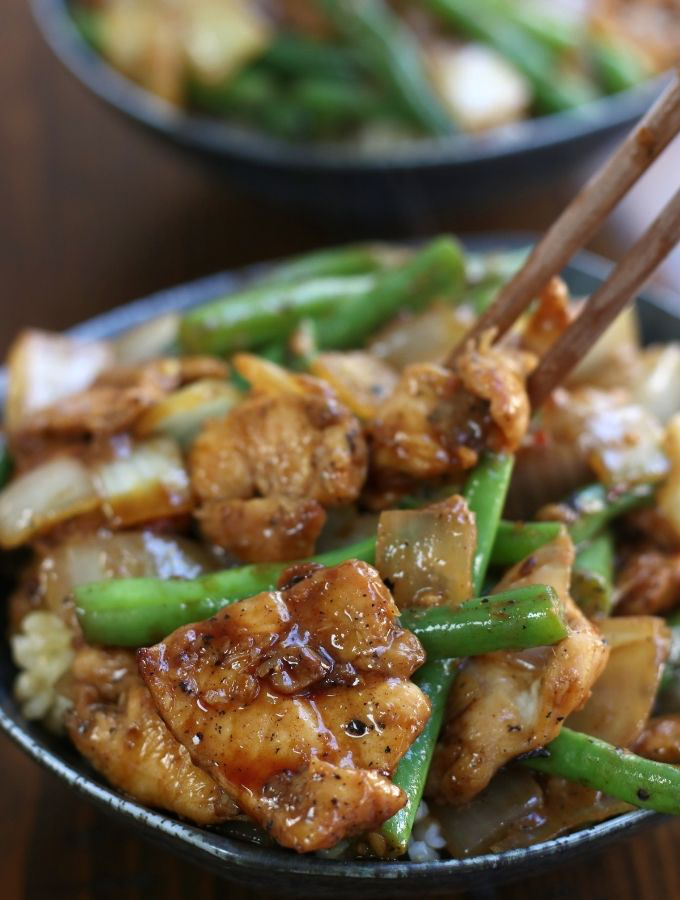 Green Bean Stir Fry being eaten with chopsticks.