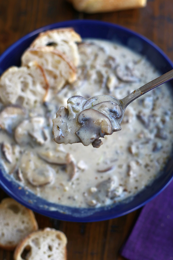 A spoonful of Mushroom Soup without cream but loaded with slices of mushrooms.