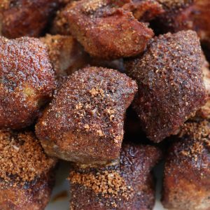 Up close photo of Country Style Pork Ribs with dry rub on a white platter.