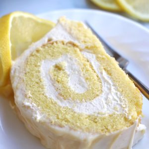 A slice Lemon Cake Roll with lemon slices.