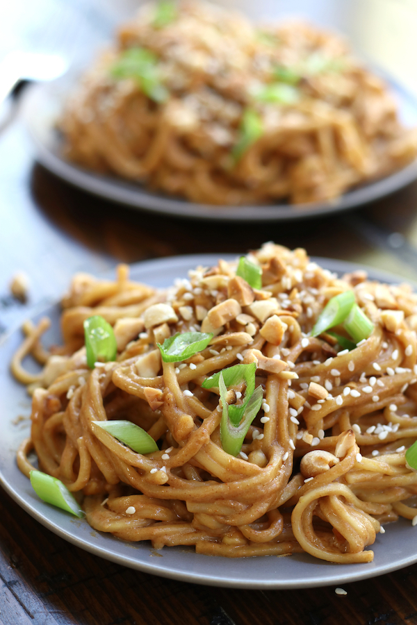 Peanut Noodles served on a plate that is sitting on a table.