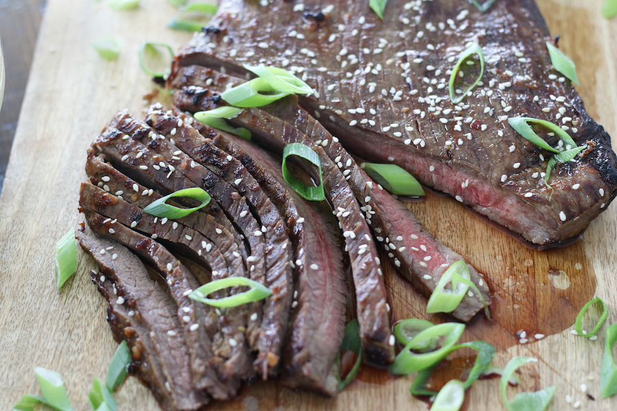 Overhead photo of steak that was marinated with Asian Flank Steak Marinade after cooking.