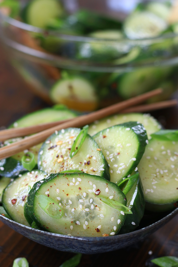 Crunchy Asian Cucumber Salad garnished with sesame seeds and green onions.