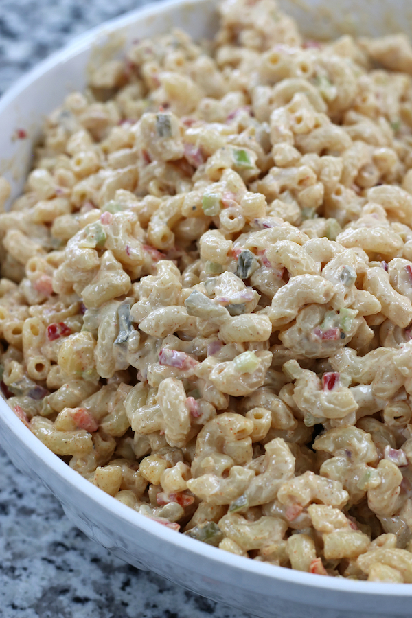 Freshly made Homemade Macaroni Salad in a white pasta bowl.