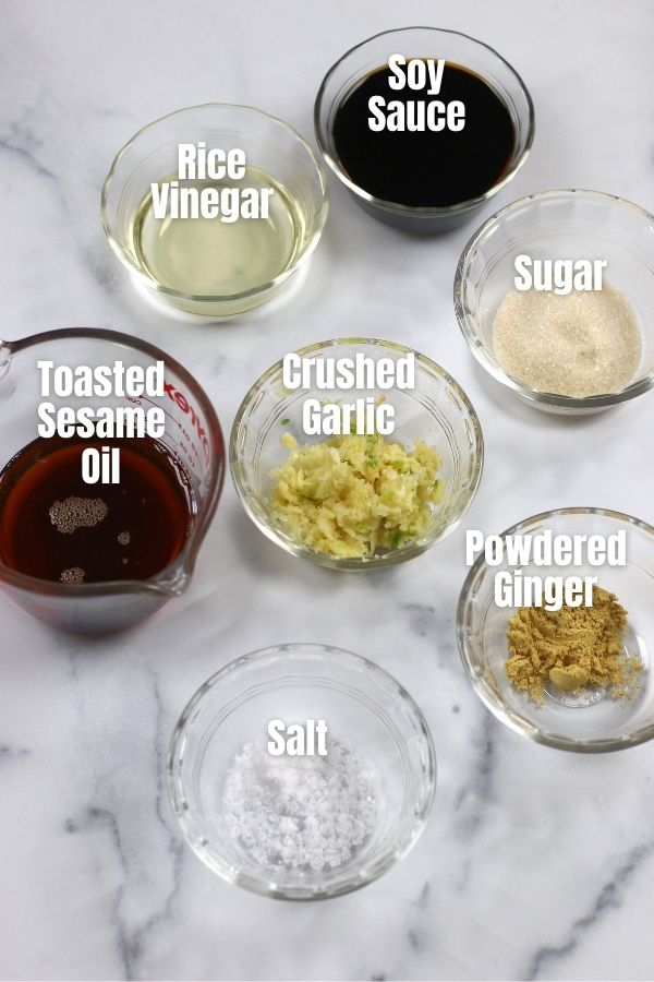 Ingredients for Asian Steak Marinade in small bowls on a white countertop.