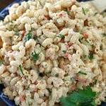 Up close photo of Macaroni Salad garnished with Italian parsley.