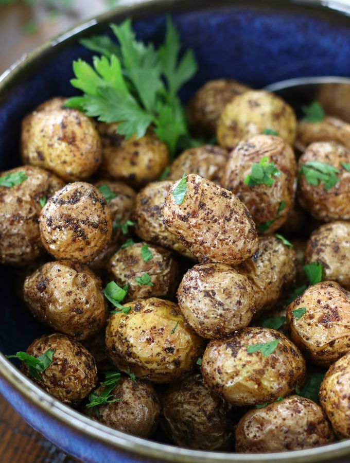 Air Fryer Baby Potatoes garnished with Italian parsley.