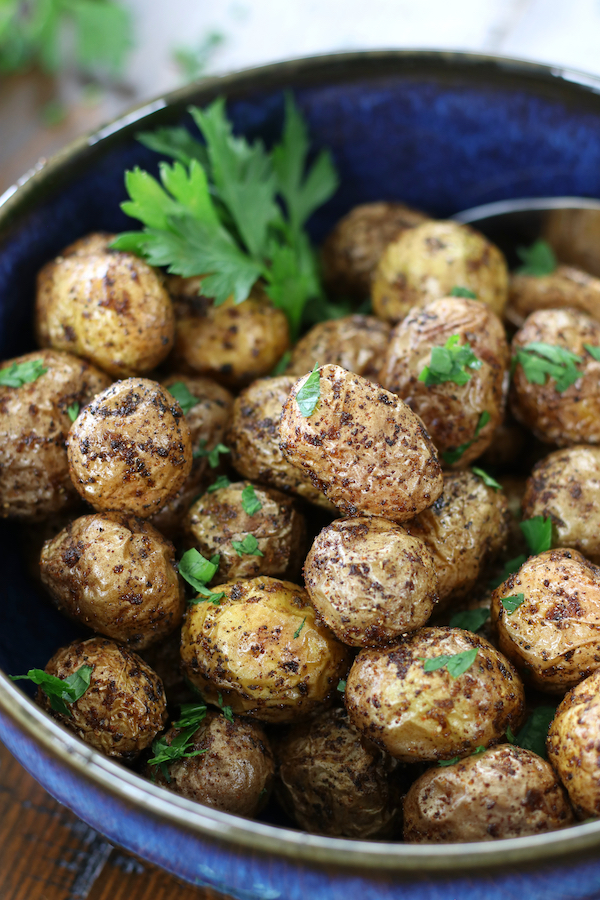 Cooked Air Fryer Creamer Potatoes served in a blue bowl.