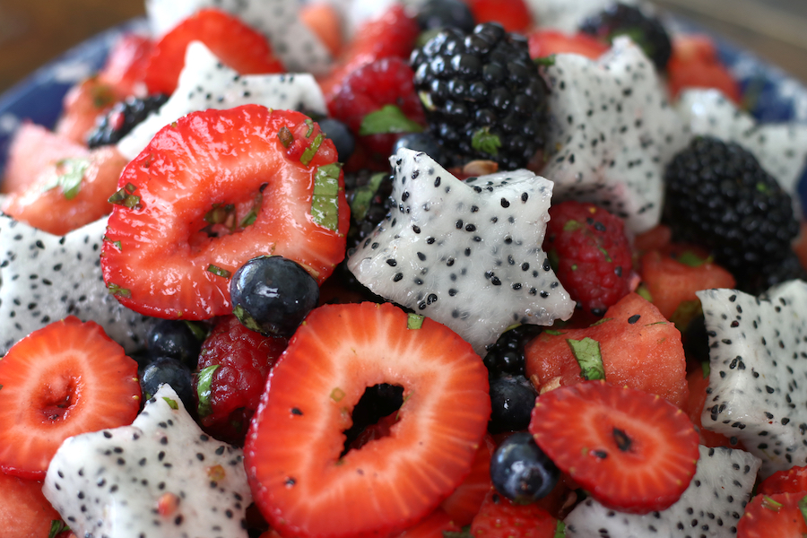 Up close photo of fruit salad with a honey lime mint dressing.