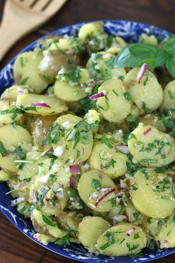 No-mayo Potato Salad in a blue bowl sitting on a wooden table.
