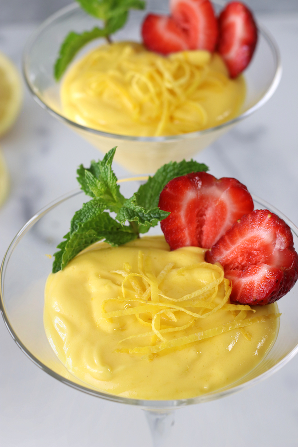 Zabaglione recipe made with limoncello and garnished with fresh mint and a cut strawberry.