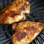 Two all purpose Air Fryer Boneless Chicken Breasts side by side in air fryer.