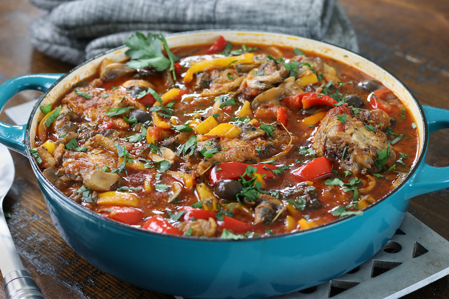 Pollo Cacciatore in a teal enameled cast iron skillet.