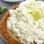 Up close photo of Key Lime Pie with fluffy lime whipped cream.