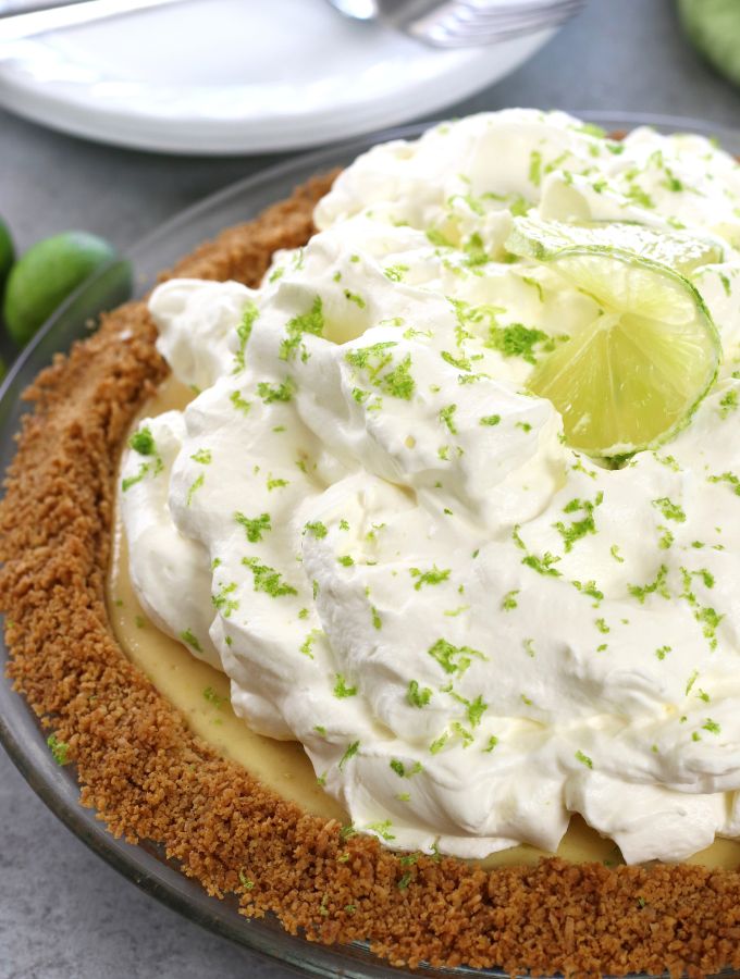 Up close photo of Key Lime Pie with fluffy lime whipped cream.