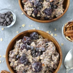 Two served bowls of Cherry Oats with chocolate chips and pecans.