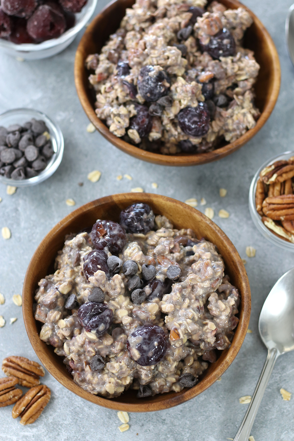 Two served bowls of Cherry Oats with chocolate chips and pecans.