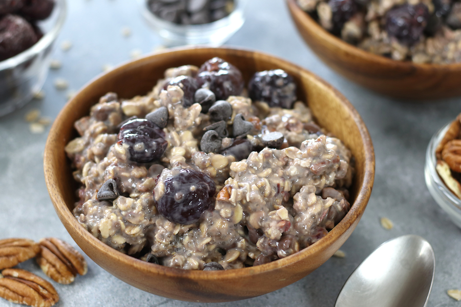 Overnight Oats with Chia Seeds and cherries served in a bowl sitting on a countertop.