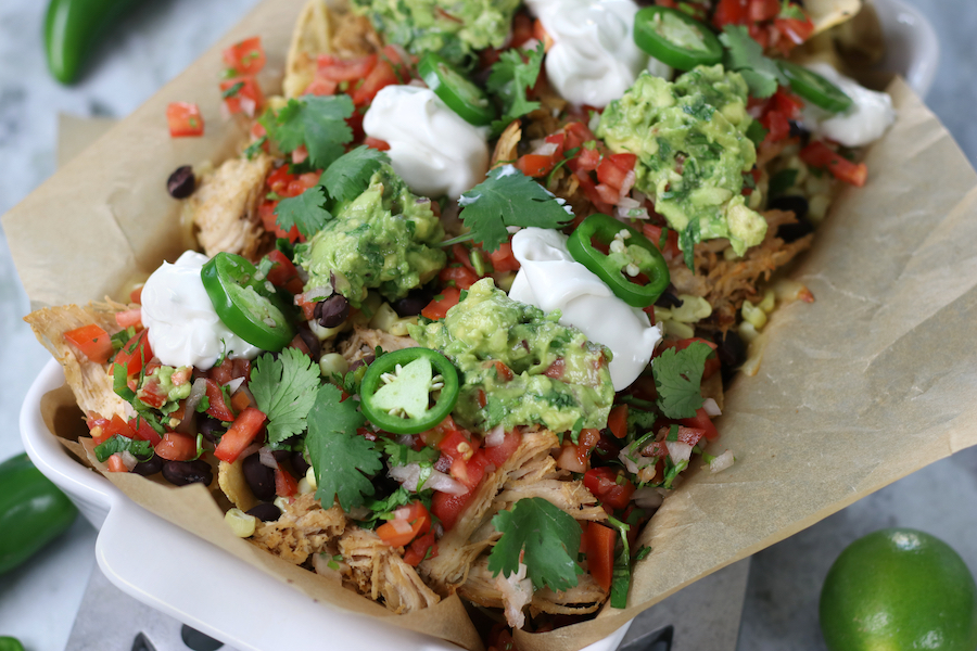 Shredded Chicken Nachos Recipe prepared in a white roasting pan.