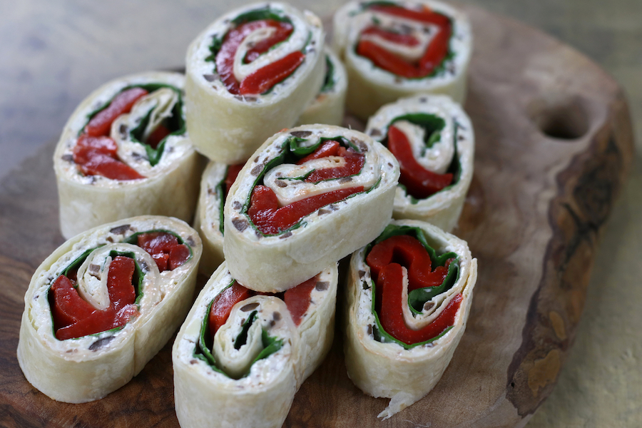 Cream Cheese Tortilla Rolls cut and laid on a board.