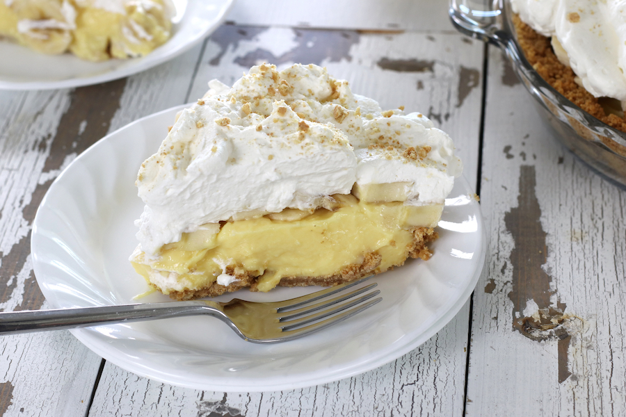 A slice of Banana Cream Pie on a white small plate.