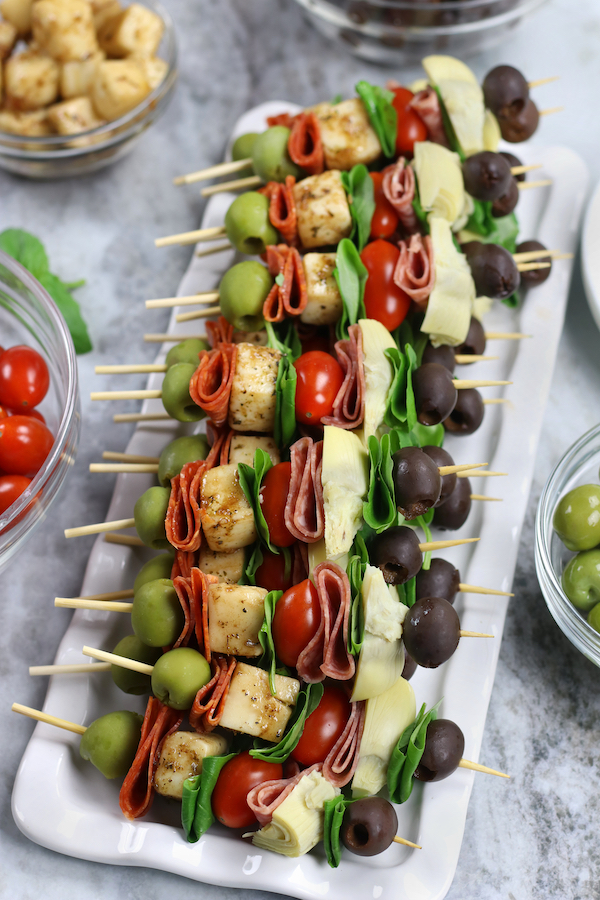 Overhead photo of Antipasto Kabobs on a white marble countertop.