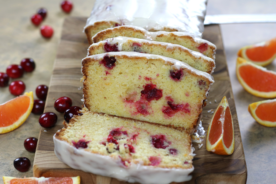 Cranberry Orange Bread Recipe sliced on a cutting board ready to serve.